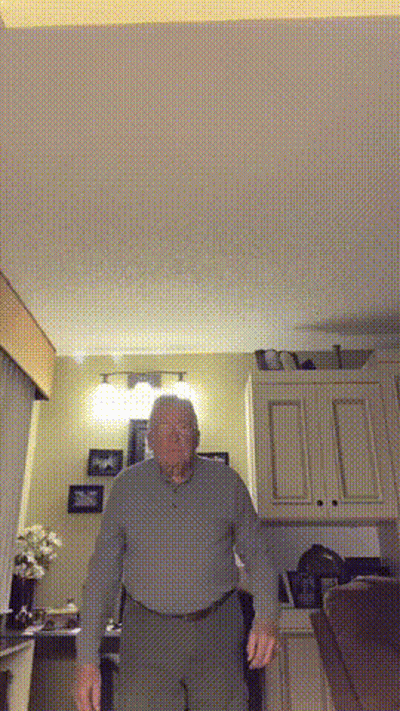 Older Man Standing In Living Room GIF