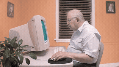 Older Man Using Computer And Mouse GIF