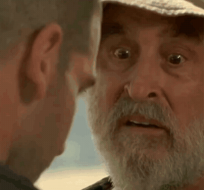 Older Man With Beard And Hat Looking At Another Man GIF