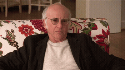 Older Man With Glasses In Floral Chair GIF