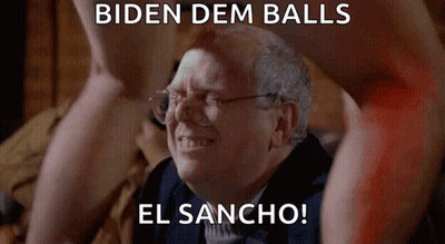 Older Man With Glasses Sitting In Front Of Naked Man's Legs GIF