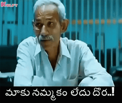 Older Man With Mustache Sitting At Table Telugu Caption GIF