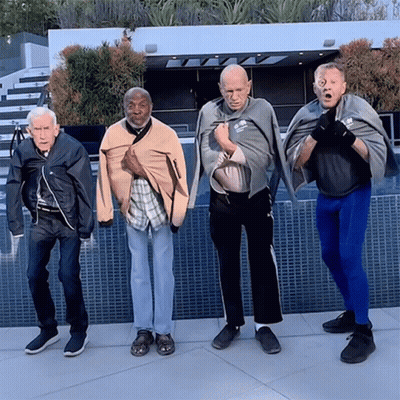 Older Men Standing Together One Wearing Reebok Shirt GIF