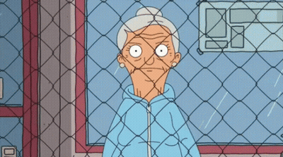 Older Woman Behind Chain Link Fence GIF