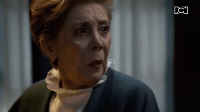Older Woman Crying In Front Of TV With BC GIF