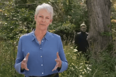 Older Woman In Blue Shirt In Forest GIF