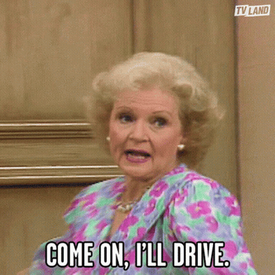 Older Woman In Floral Dress Says Come On I'll Drive GIF