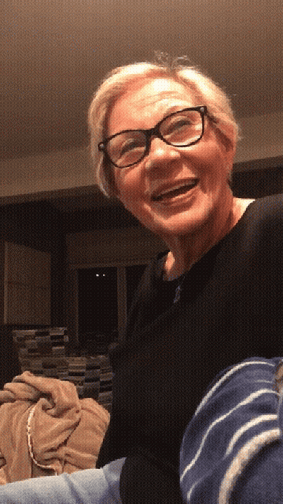 Older Woman In Glasses And Black Shirt Smiling GIF
