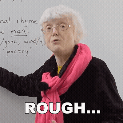 Older Woman In Glasses And Pink Scarf Saying Rough GIF