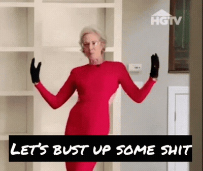 Older Woman In Red Dress And Black Gloves In Front Of HGTV Sign GIF