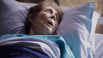 Older Woman Laying In Hospital Bed With RC Letters GIF