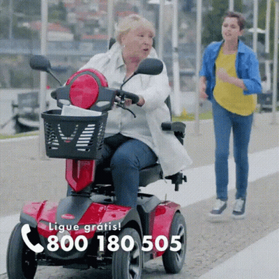 Older Woman Riding Scooter With Number 800 180 505 GIF
