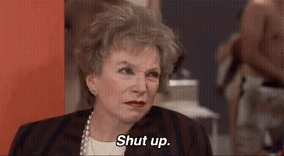 Older Woman Saying Shut Up Sitting In Room GIF