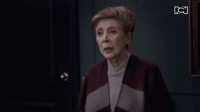 Older Woman Standing In Front Of Door With BC GIF