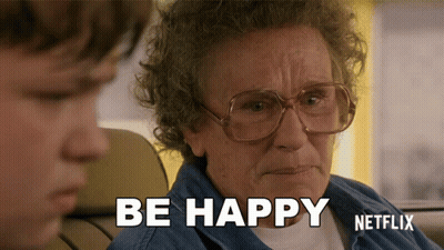Older Woman With Glasses Says Be Happy Next To Young Boy GIF