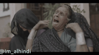 Older Woman With Mouth Open Comforted By Woman In Hijab GIF