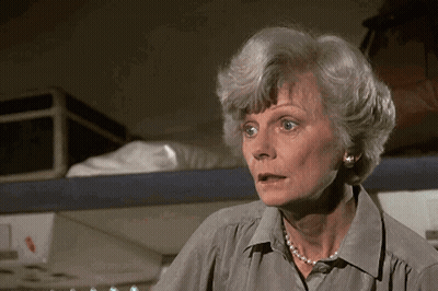 Older Woman With Pearl Necklace And Earrings Surprised GIF