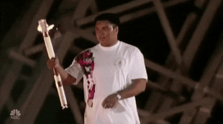 Olympic Man Lights Torch GIF