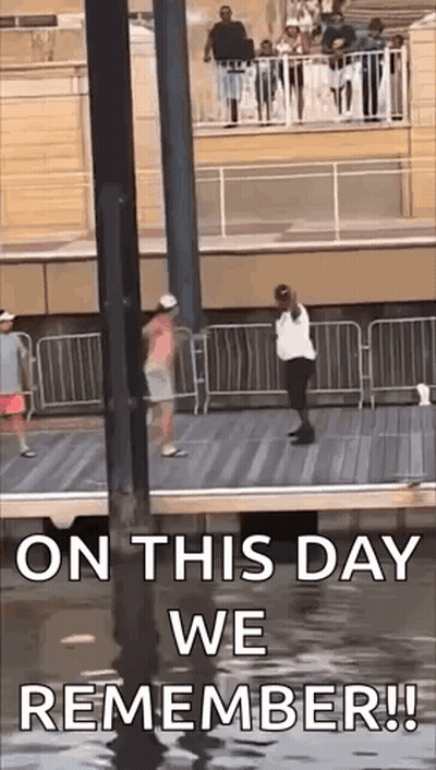 On This Day We Remember ! A Man And A Woman Are Standing On A Pier . GIF