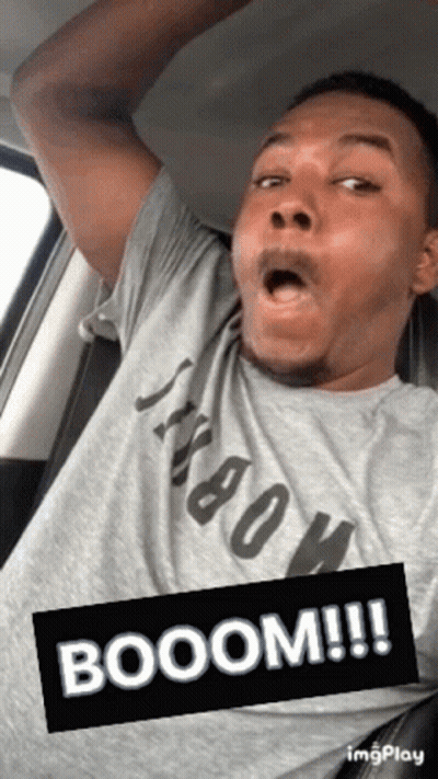 Open-Mouthed Man In Grey Shirt In Car GIF