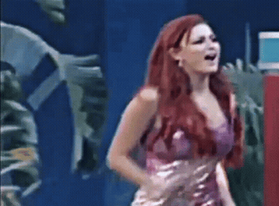 Open-Mouthed Red-Haired Woman In Purple Dress On Stage GIF