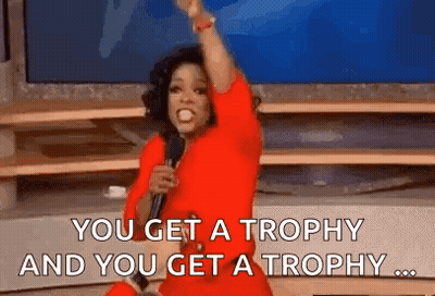Oprah Winfrey Is Holding A Microphone And Saying `` You Get A Trophy And You Get A Trophy ... '' . GIF
