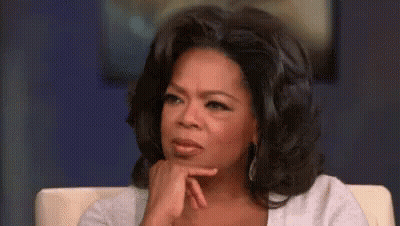 Oprah Winfrey Is Sitting In A Chair With Her Hand On Her Chin And A Serious Look On Her Face . GIF