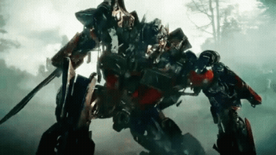 Optimus Prime Holding Sword And Shield In Forest GIF