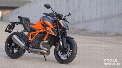 Orange And Black Motorcycle Parked Saying Cycle World GIF