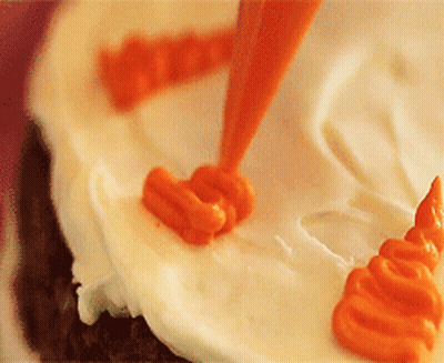 Orange Frosting Applied To White Cake GIF