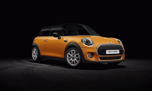 Orange Mini Cooper Parked On Black Background GIF