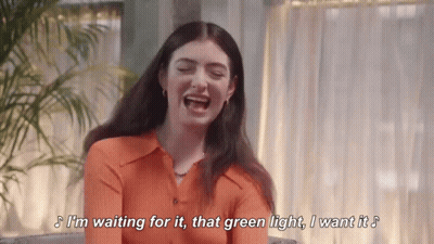 Orange Shirt Woman Laughing Waiting For Green Light GIF
