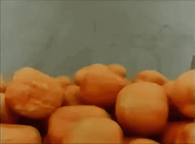 Oranges Being Peeled On Conveyor Belt GIF