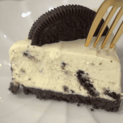 Oreo Cheesecake Slice With Gold Fork GIF