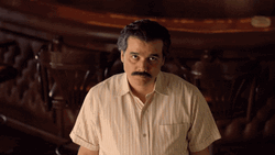 Pablo Escobar Chewing And Staring GIF