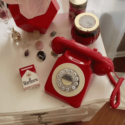 Pack Of Marlboro Cigarettes Next To Red Telephone GIF