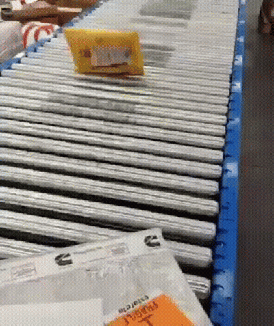 Package On Conveyor Belt Saying Fragile GIF