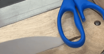 Pair Of Blue Scissors On Wood GIF