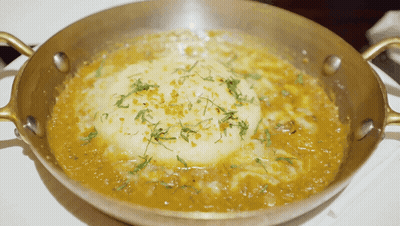 Pan Of Food With Thick Sauce And Crust GIF