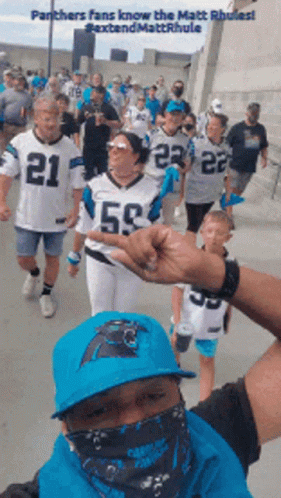Panthers Fans Walking Down Sidewalk GIF