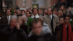 Papa Elf Walking Among The Crowd GIF