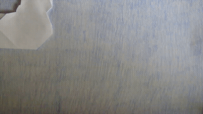 Paper Airplane Folded In Half On Blue Surface GIF