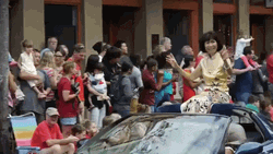 Parade Woman Sitting In Car Roof GIF