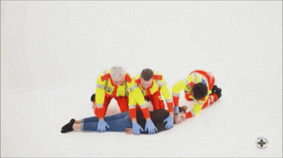 Paramedics Helping Woman Lying On Floor GIF