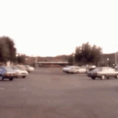 Parking Lot With Cars And Building GIF