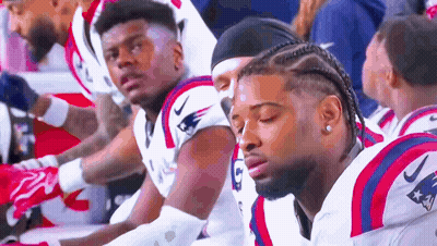 Patriots Football Players Sitting On Sidelines GIF