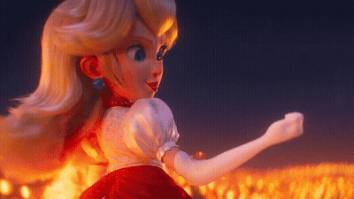 Peach Doll Standing In Front Of Flames GIF