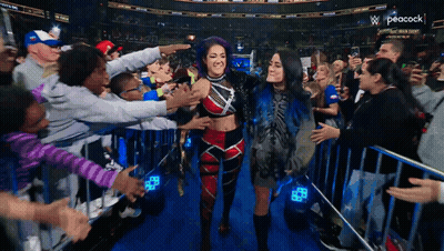 Peacock Logo Behind Crowd Of People GIF