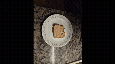 Peanut Butter Bottle Next To Toast And Knife GIF