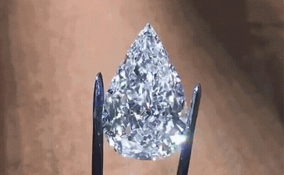 Pear Shaped Diamond Held By Tweezers GIF